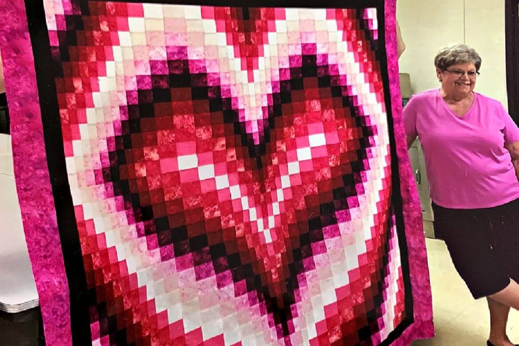 mom with her heart quilt